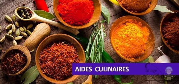 Profils de diverses épices colorées dans des bols en bois, sur un fond en bois avec des herbes, illustrant des recettes culinaires et la cuisine aromatique pour inspirer la cuisine maison et professionnelle.