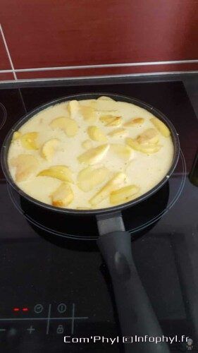 Matafan aux pommes dans une poêle, cuisson crémeuse avec morceaux de pommes dorées, parfait pour une douceur maison.